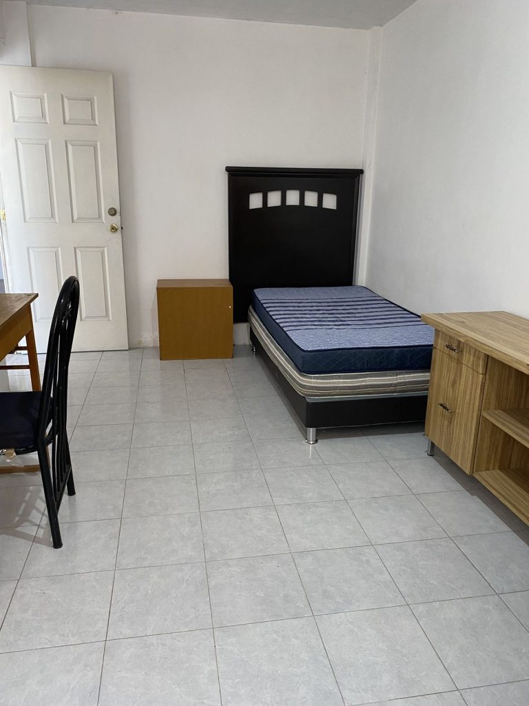 Double sharing girls PG room in Karnal with beds and study furniture