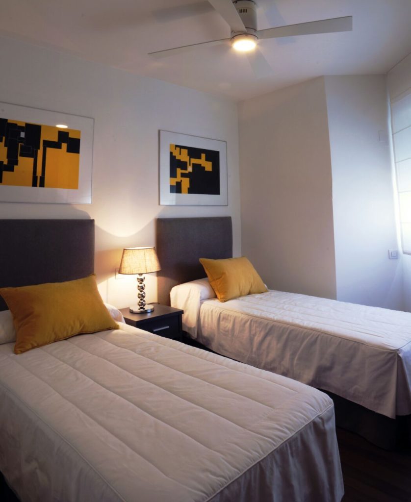 Storage ideas for small PG rooms with organized bed, wardrobe and study area